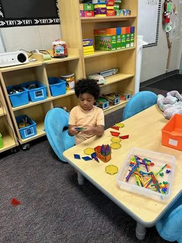 A child sitting at the table in a room.