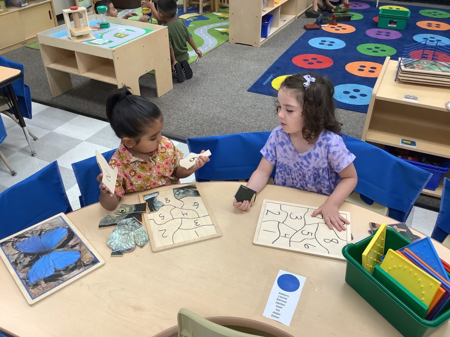 Two young girls are playing a game together.